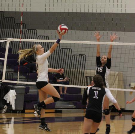 In Tuesday's night battle with cross town rival Guyer, Jade Akins goes up for a point.