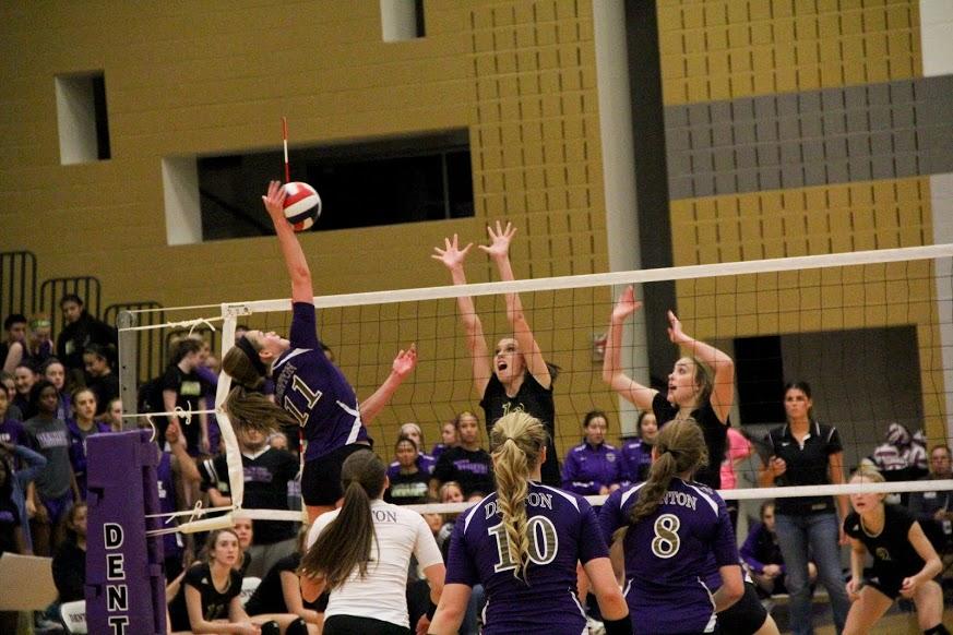 Junior Kenzie Dozer spikes the ball past two Rider players during Denton's 3-2 win over the visiting Raiders