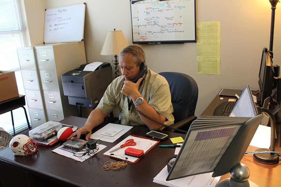 Coach Harrison is seen interacting with parents over the phone on his first day as Assistant Principal.