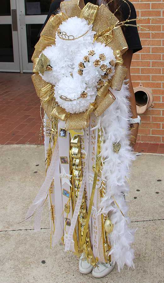 A student displays her oversized mum at last year’s homecoming carnival.