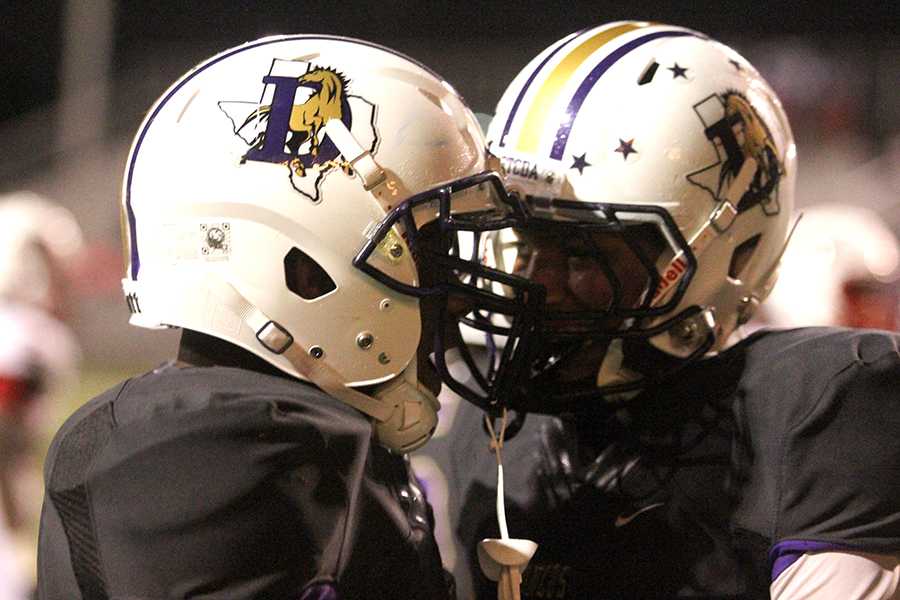 Seniors Key’andre Hearvey (right) and Joe Gloria celebrate after Hearvey scores a touchdown during Denton’s 42-23 win over Carrollton Creekivew.