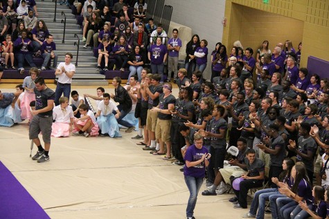 Senior football player Rowdy Clark is given a standing ovation by his teammates as he approaches the microphone to speak during a pep rally.
