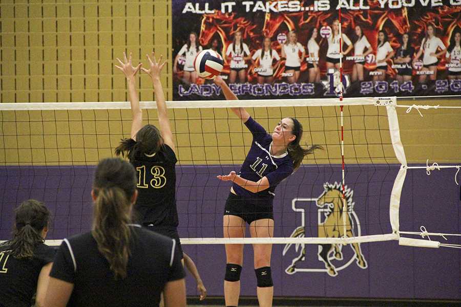 Junior Kenzie Dozer spikes the ball past a Rider player during Denton’s close 3-2 win over the Raiders. The victory put the Lady Broncos in sole possession of first place.