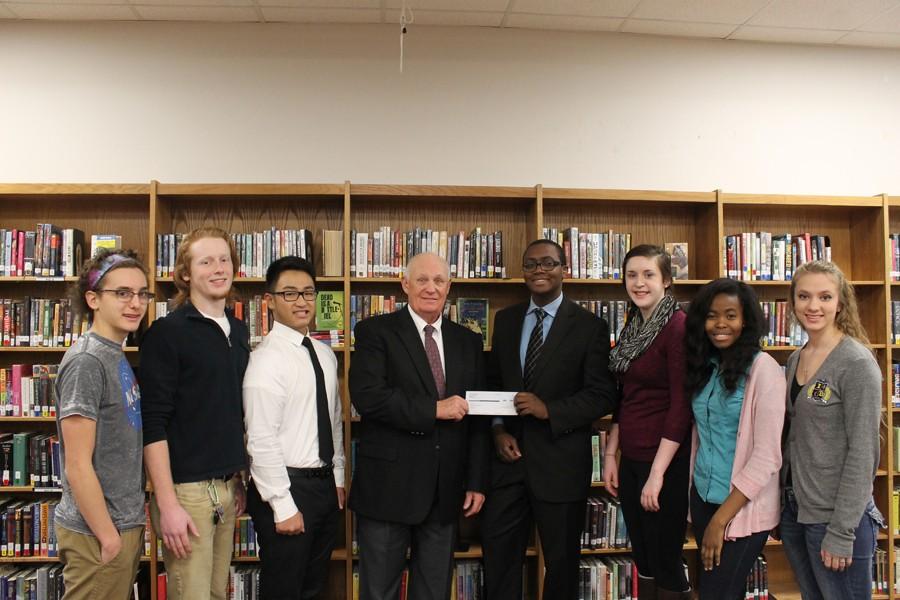 The IB Diploma Programme was awarded a $20,000 grant from the Miles Foundation. Pictured Left to Right are Jared Ramirez, 12, Julian Moberly, 12, Dominik Tran,12, Miles Foundation President, Jack Burdett, Percy Seddoh, 11, Rose Koeninger, 11, Adinawa Adjagbodjou, 11, and Hannah Bowen, 11.