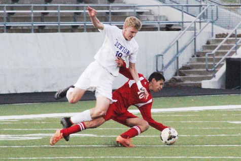 Varsity Offender, Zach Alspach (19) attempts to fight an Eagle defender to gain control of the ball.